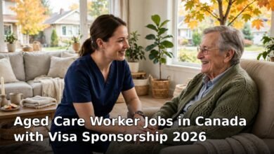 Aged care worker supporting an elderly client with mobility assistance in a bright Canadian home, 2026